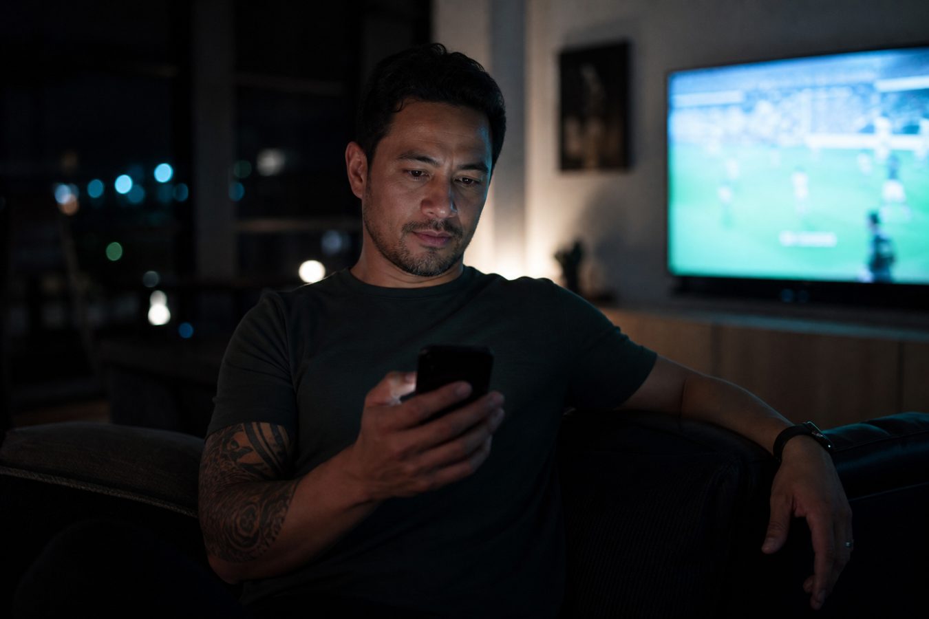 Reviewing on the phone on the couch while the TV is on
